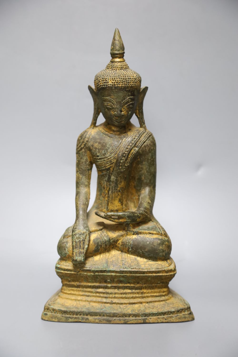 An 18th century Burmese Buddha, with traces of original gilding on bronze, height 27cm